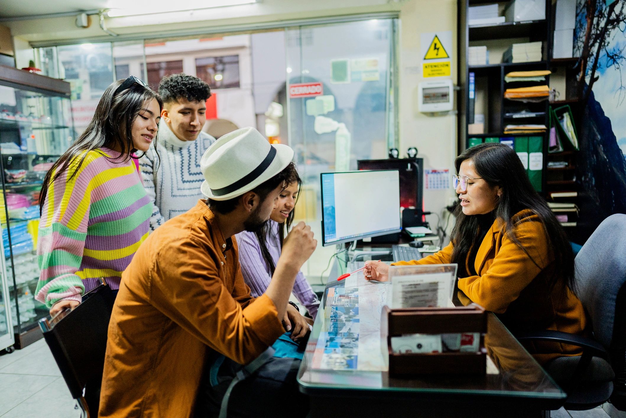 Travelers speaking with a travel consultant in an office